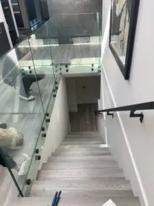 showcasing the installation or an all glass railing.