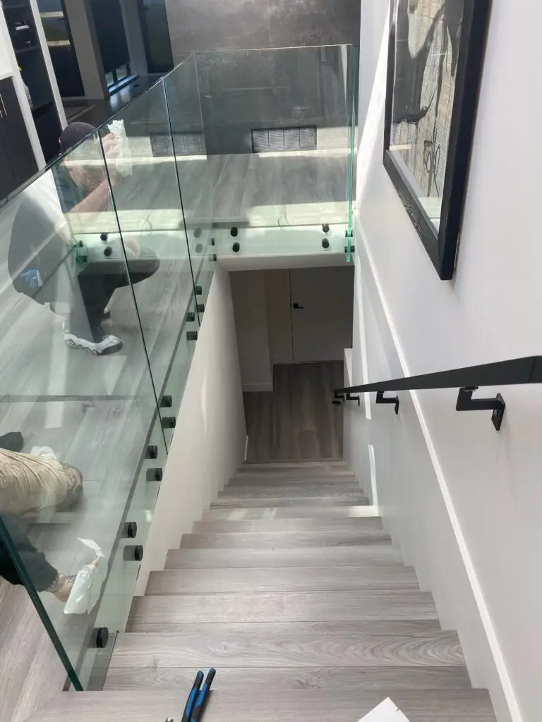 showcasing the installation or an all glass railing.